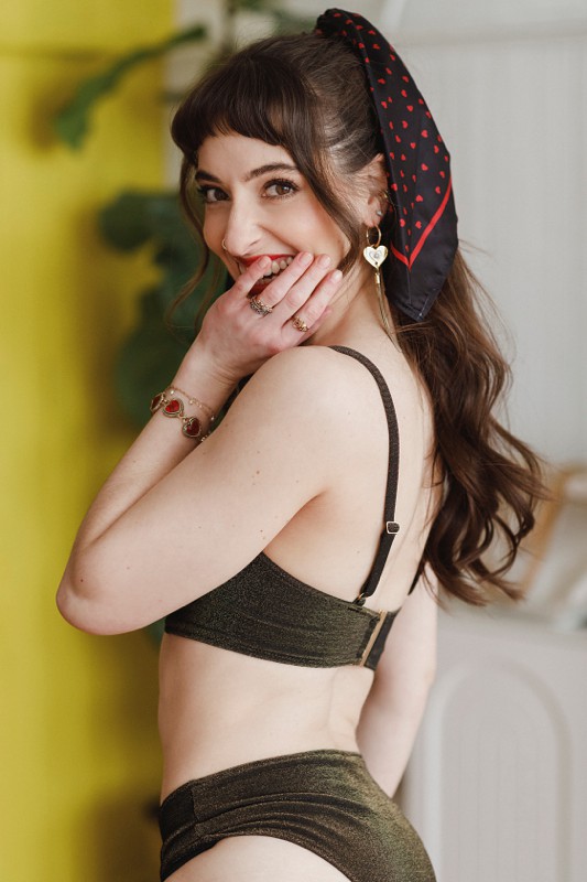 woman covers mouth in a bra and underwear set by kate moss in a chicago boudoir studio